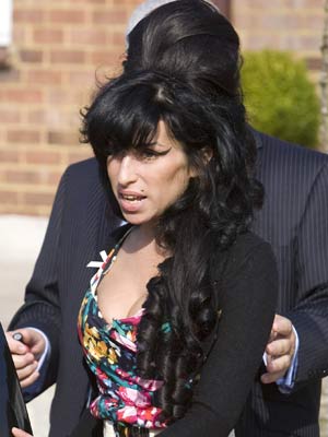 SEE PICS Amy Winehouse tearful as she returns to UK