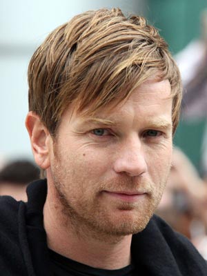 Y-Mc-C-A! Ewan McGregor looks like one of The Village People with dramatic new black hair and moustache 