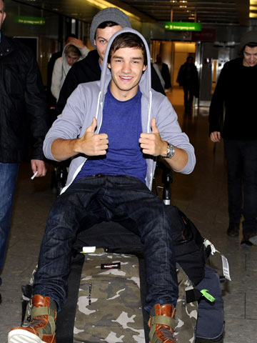 One Direction arrive back in London after recording new album in Sweden