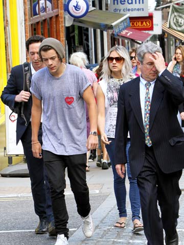 One Direction's Harry Styles hides hair under hat as he hunts for new house in London with Lou Teasdale