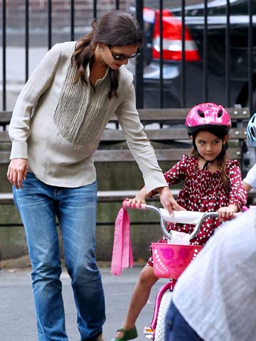 Katie Holmes teaches daughter Suri Cruise how to ride a bike in New York