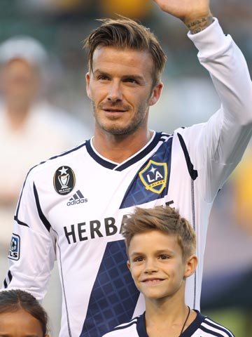 David Beckham is joined by birthday boy Romeo on the pitch at LA Galaxy match