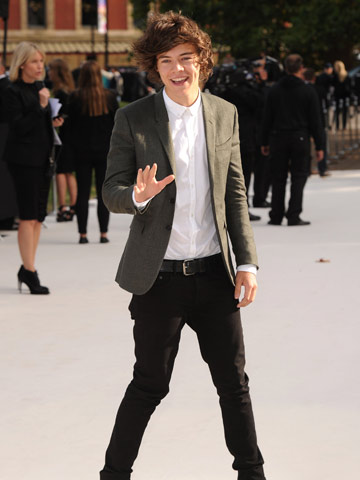 One Direction star Harry Styles sits front row with Dev Patel and Dita Von Teese at LFW Burberry Prorsum Show 