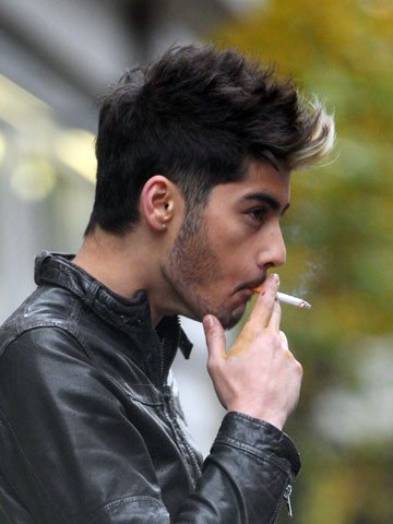 Zayn Malik snapped smoking in London after hosting Capital FM charity show with One Direction 