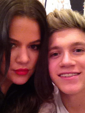 Khloe Kardashian meets 'cuteness' One Direction on US X Factor before London fashion launch with sister Kim