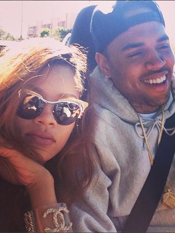 Watch out, Chris Brown! Rihanna snapped kissing mystery man!