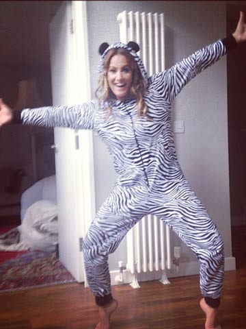 Harry Styles' ex Caroline Flack has fun in zebra onesie - shame her sexy legs are hidden
