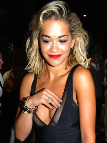 Rita Ora strips! Singer risks nipple slip as she whips off bra while partying in New York